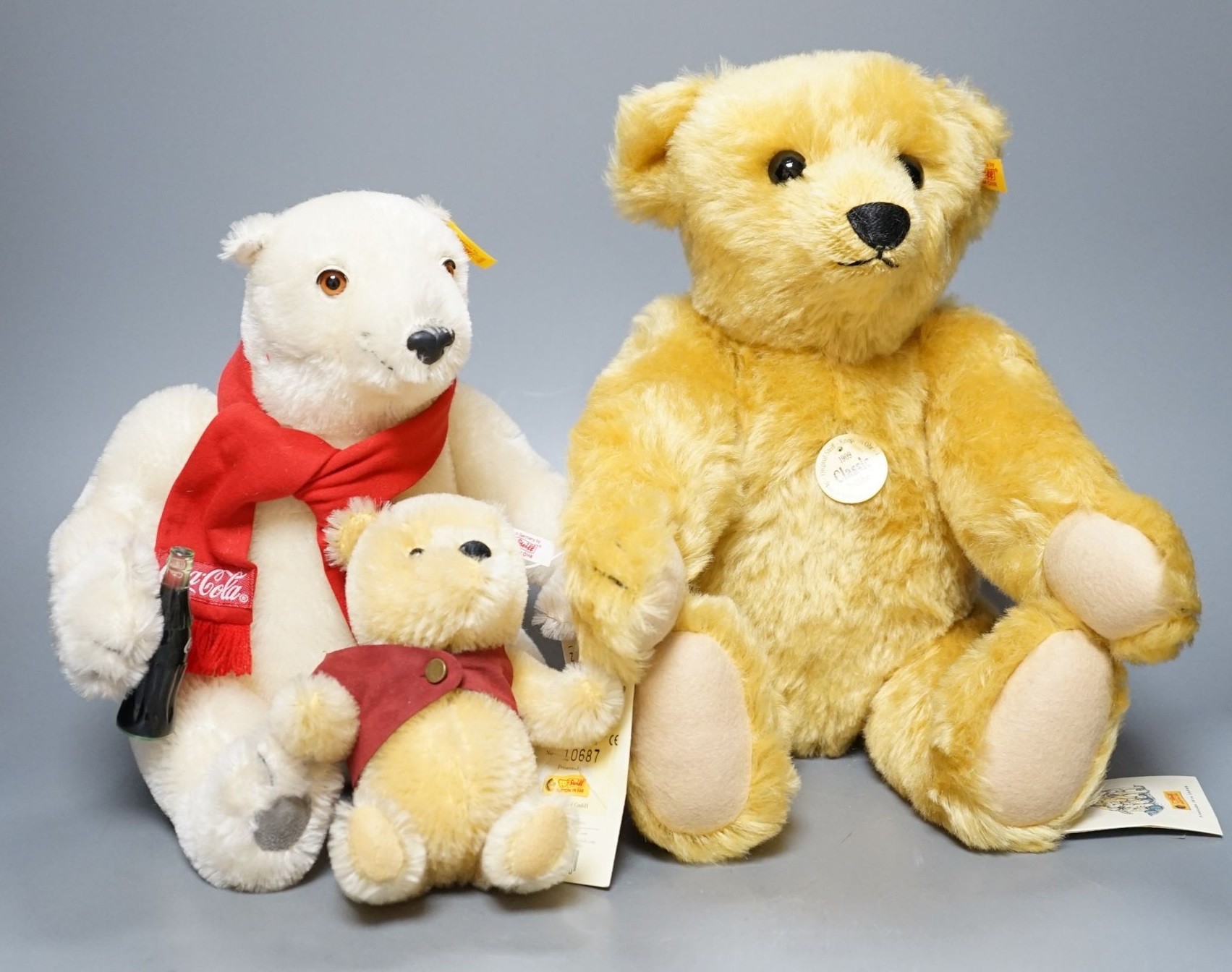 A Classic Bear Steiff, box, 43cm, with a yellow tag, a Coco Cola Bear Danbury Mint, 28cm with Winnie The Pohh Steiff, box, 18cm